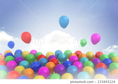 Colorful flat design latex balloons are clustering at bottom against sky with clouds while floating Colorful flat design latex balloons are clustering at bottom against sky with clouds while floating 133845224