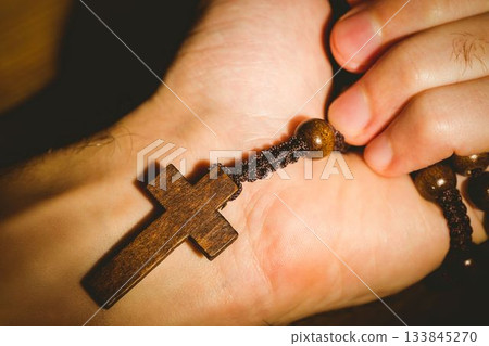 Hand holding rosary beads Hand holding rosary beads 133845270