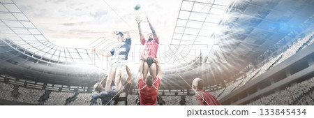 Low angle view of multiracial players carrying teammates on shoulders and chasing ball in stadium 133845434