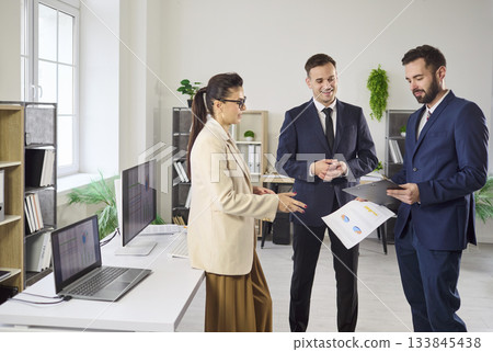 Business colleagues discussing reports in office, strategy planning and teamwork 133845438