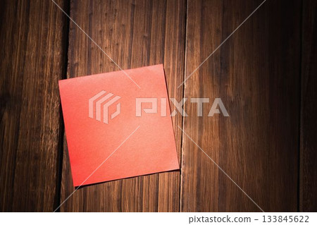 Orange paper on wooden floor 133845622