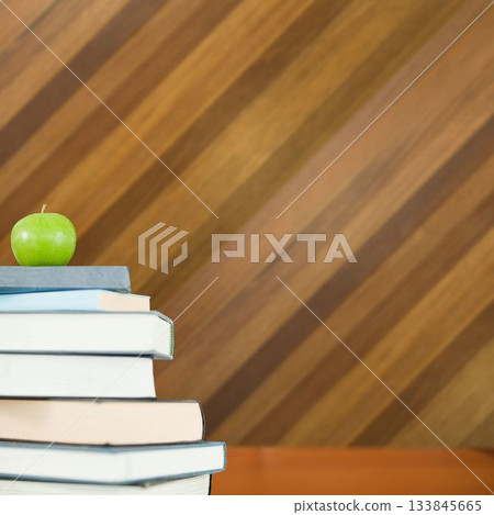 Green apple on pile of books Green apple on pile of books 133845665