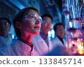 A group of scientists are watching the experiment in awe in the laboratory. 133845714