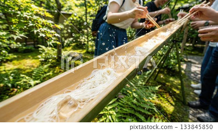 People enjoying the summer tradition of "Nagashi Somen" with bamboo and green maples People enjoying the summer tradition of "Nagashi Somen" with bamboo and green maples 133845850