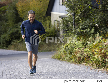 A man in his 50s running A man in his 50s running 133845990