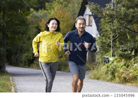 A middle-aged couple running 133845996