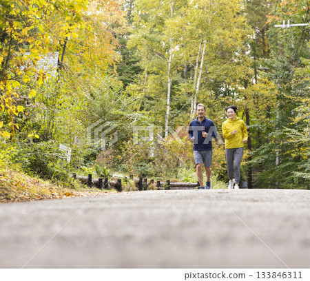 A middle-aged couple running 133846311