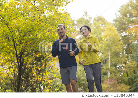 A middle-aged couple running A middle-aged couple running 133846344