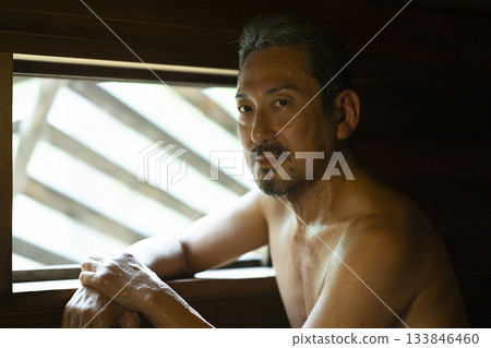 A man in his 50s enjoying the sauna A man in his 50s enjoying the sauna 133846460