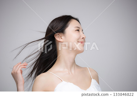 Portrait of a woman with long black hair blowing in the wind. Image of beauty, hair care, treatment, etc. Portrait of a woman with long black hair blowing in the wind. Image of beauty, hair care, treatment, etc. 133846822