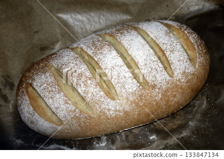 Close up of home made freshly baked bloomer of bread Close up of home made freshly baked bloomer of bread 133847134