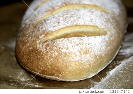 Close up of home made freshly baked bloomer of bread Close up of home made freshly baked bloomer of bread 133847141