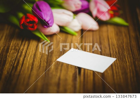 Flat design is showing blank white card on wooden tabletop with pink tulip flowers, copy space Flat design is showing blank white card on wooden tabletop with pink tulip flowers, copy space 133847673