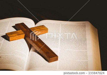 Wooden cross kept on bible 133847824