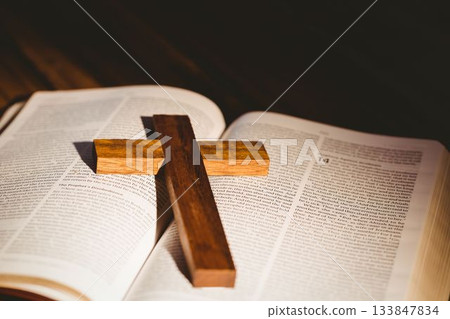 Wooden cross on open bible Wooden cross on open bible 133847834