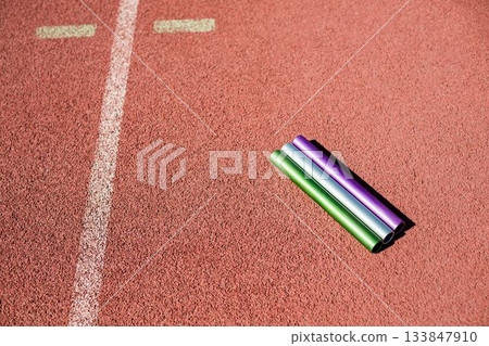 High angle view of baton on running track High angle view of baton on running track 133847910