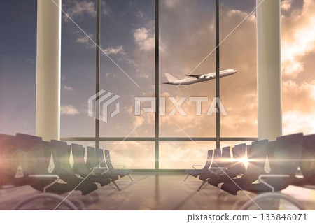 Airplane flying past departures lounge window Airplane flying past departures lounge window 133848071