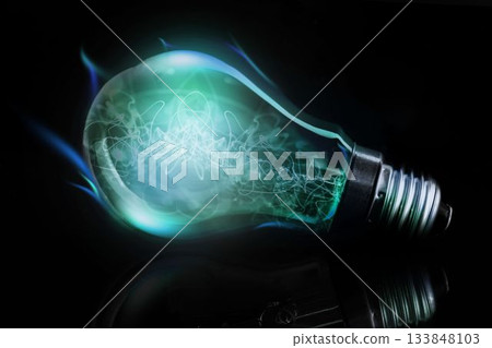Green-blue filament light bulb is lying in 3D render on glossy black surface with metallic base 133848103