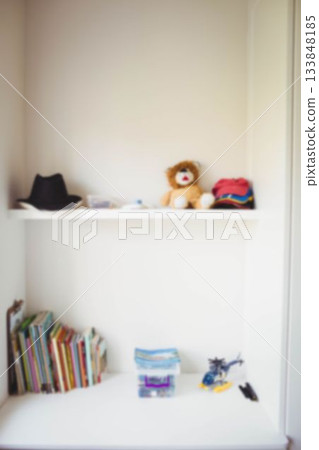 Toys and books in white shelf 133848185