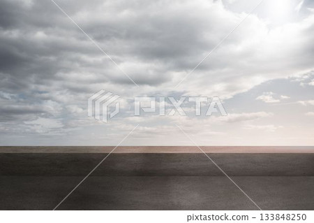 Empty paved surface is stretching toward horizon in flat design, featuring overcast sky, copy space 133848250