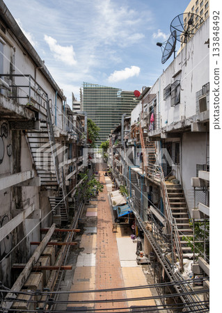 Narrow alleyway in Bangkok showcasing urban architecture and vibrant street life atmosphere 133848492