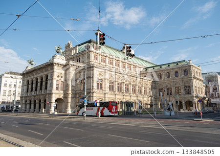 The Vienna State Opera House seen from a street corner, featuring its grandeur and neoclassical design The Vienna State Opera House seen from a street corner, featuring its grandeur and neoclassical design 133848505