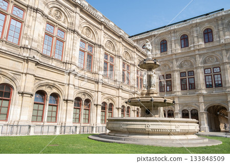 A detailed side view of the courtyard fountain at the Vienna Opera House. A detailed side view of the courtyard fountain at the Vienna Opera House. 133848509