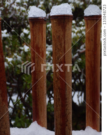 Sleet piled up at the end of the bamboo fence Sleet piled up at the end of the bamboo fence 133848723