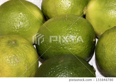 Close up of fresh green lime fruits on white background Close up of fresh green lime fruits on white background 133848780