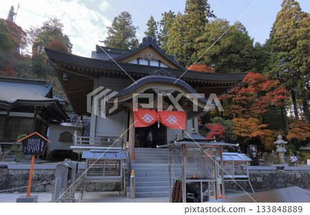 Autumn leaves and Bishamonten statue near the main hall of Unpenji Temple, the 66th temple of the Shikoku Pilgrimage Autumn leaves and Bishamonten statue near the main hall of Unpenji Temple, the 66th temple of the Shikoku Pilgrimage 133848889