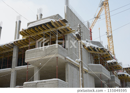 Concrete Structure Rising Through Light Falling Winter Snow 133849395