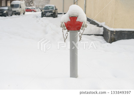 Snow-Covered Fire Hydrant Standing in Winter Street Snow-Covered Fire Hydrant Standing in Winter Street 133849397