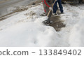 Clearing Snow From Sidewalk During Cold Winter Weather 133849402