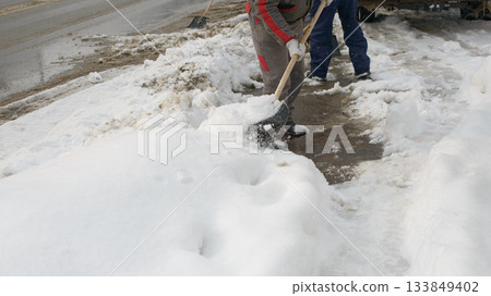 Clearing Snow From Sidewalk During Cold Winter Weather 133849402