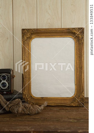 Photo frame and camera on table 133849531