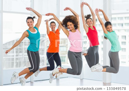 Five women are jumping in fitness studio, flat design with tank tops, leggings, sneakers, windows Five women are jumping in fitness studio, flat design with tank tops, leggings, sneakers, windows 133849578
