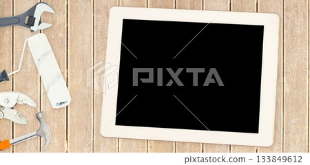 Tools and tablet on wooden background Tools and tablet on wooden background 133849612