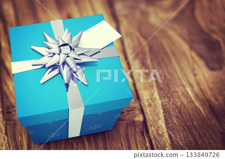 Flat design is featuring close-up blue gift box with white ribbon, silver bow, small white tag Flat design is featuring close-up blue gift box with white ribbon, silver bow, small white tag 133849726