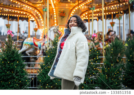 indian woman standing by christmas carousel at senate square helsinki indian woman standing by christmas carousel at senate square helsinki 133851358