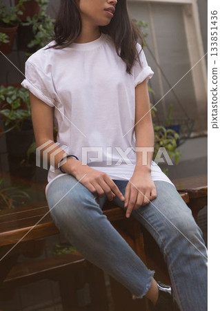 Woman is sitting on wooden bench in outdoor patio with potted plants, in flat design 133851436