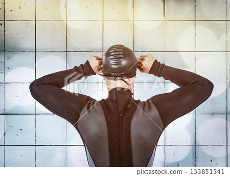 Rear view of swimmer against wall 133851541