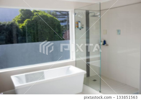 Empty bathtub by window in modern bathroom Empty bathtub by window in modern bathroom 133851563