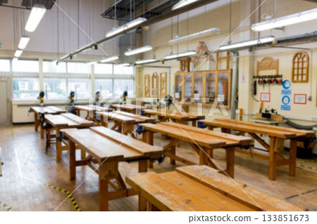 Flat design workshop showing rows of benches with vices and power tools under windows 133851673
