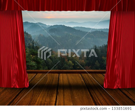 Flat design showing red velvet curtains framing wood stage planks with misty hills under rising sun 133851691
