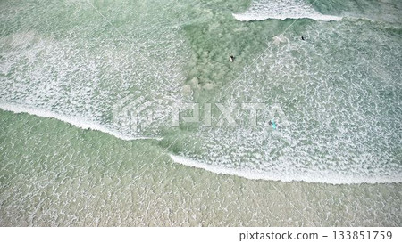 Blue ocean, Surfers in ocean, Areal view Blue ocean, Surfers in ocean, Areal view 133851759