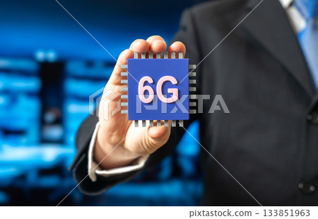 A businessman holds a 6G electronic chip. A new standard in communications technology. Network modernization. Technology news, telecom innovation, and the evolution of high-speed connectivity. 133851963