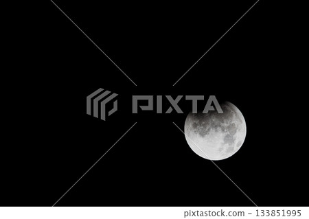 A total lunar eclipse floating in the night sky 133851995