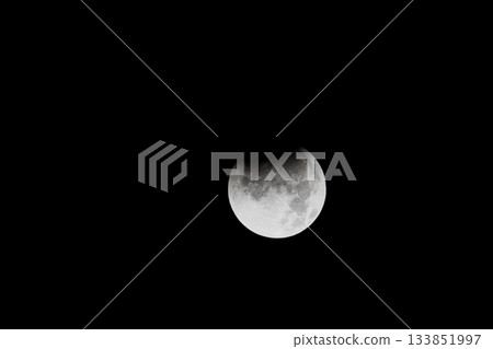 A total lunar eclipse floating in the night sky 133851997