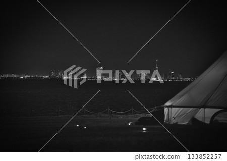 Night view and seaside landscape with tents - film-like monochrome photograph Night view and seaside landscape with tents - film-like monochrome photograph 133852257