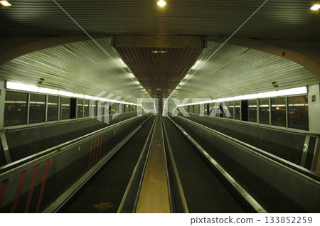 escalators of the train station that go to the platform escalators of the train station that go to the platform 133852259